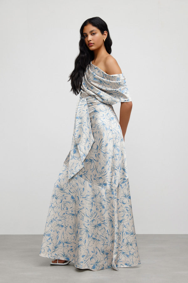 A side view of a model standing against a white background wearing Significant Other's Iona Dress in Illustration Floral.