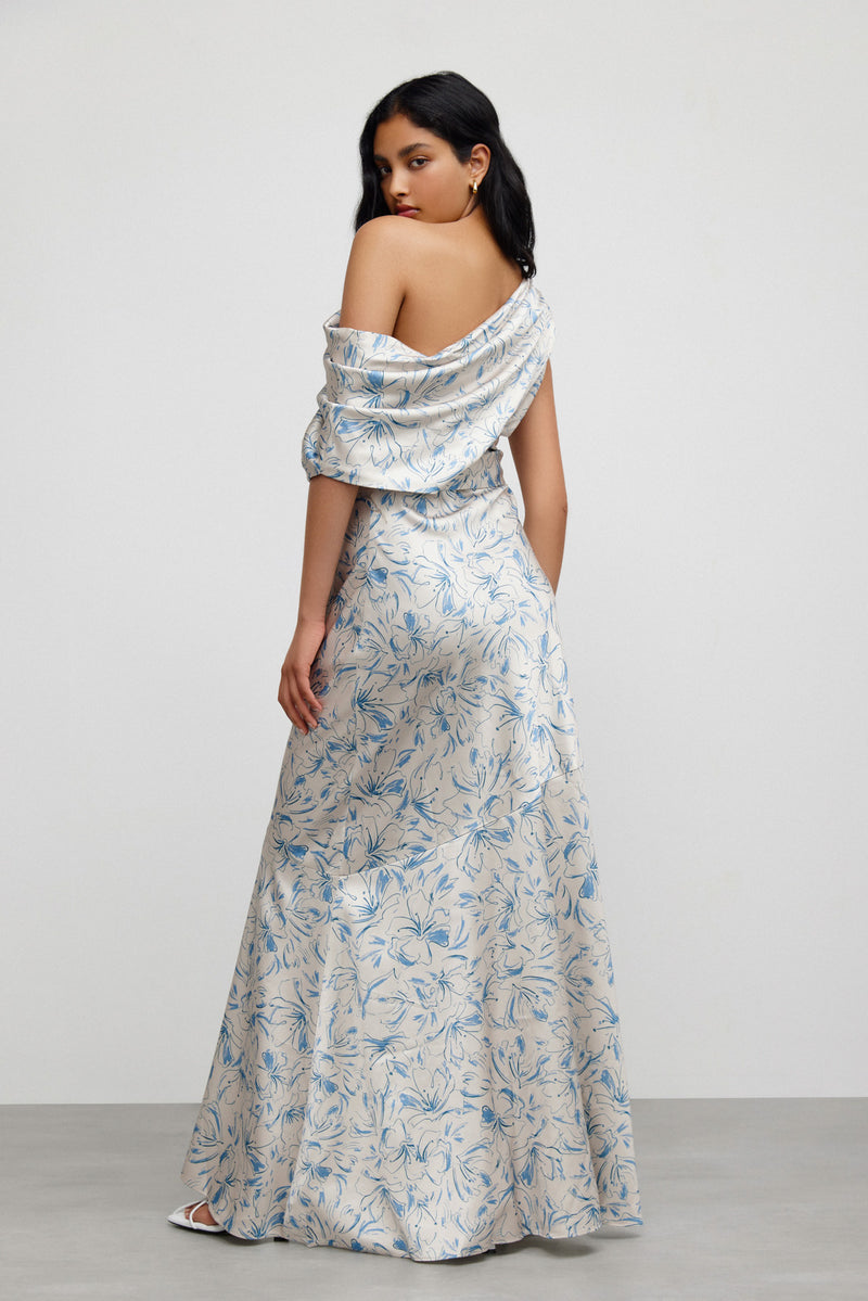 A back view of a model standing with their head over their shoulders against a white background wearing Significant Other's Iona Dress in Illustration Floral.