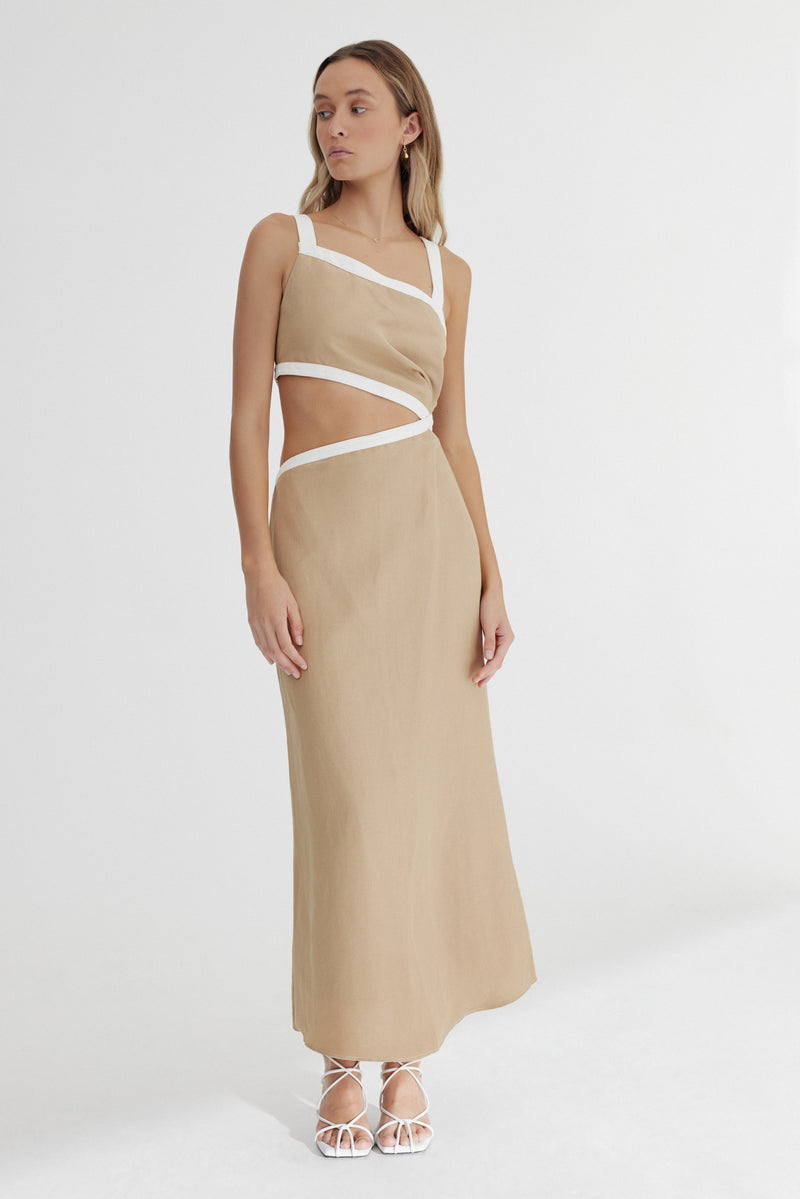 A model stands against a white background wearing Significant Other's Elena Midi Dress in Sand.