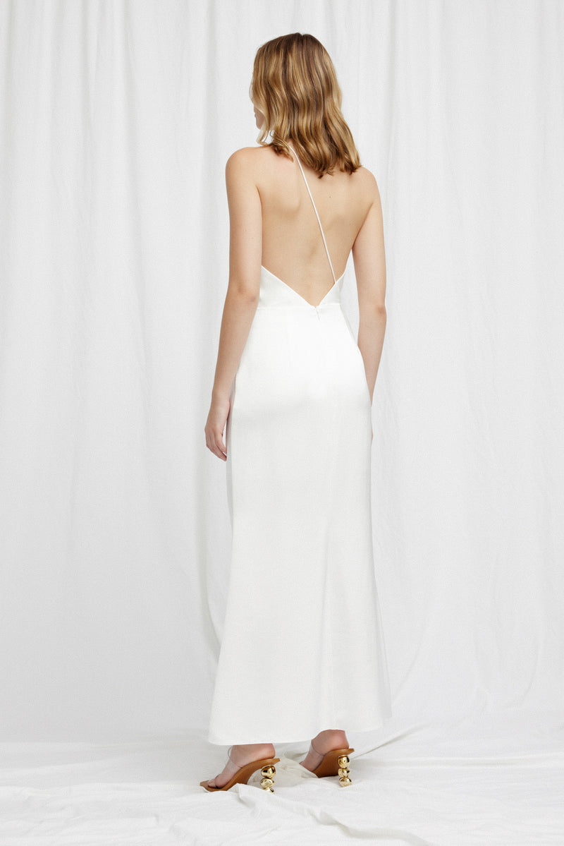 A back view of a model standing against a white background wearing Significant Other's Gracie Dress in Ivory.