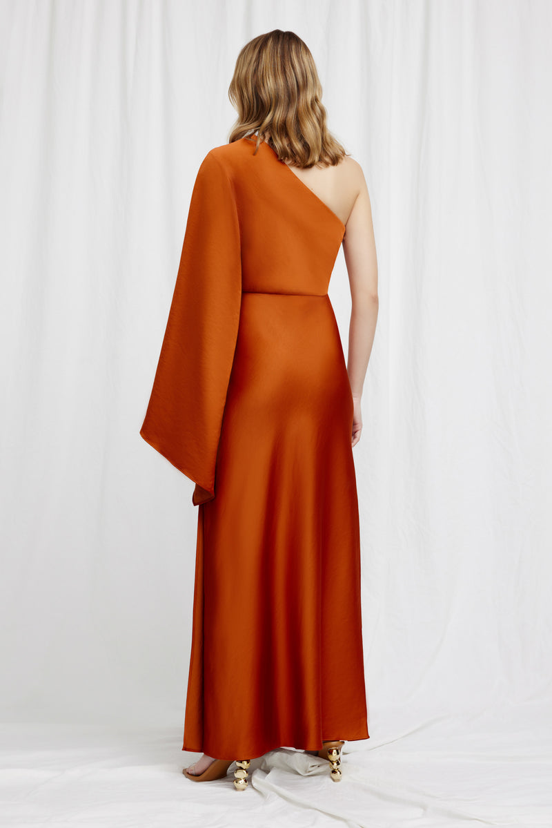 A back view of a model standing against a white background wearing Significant Other's Kelsie Dress in Clay.